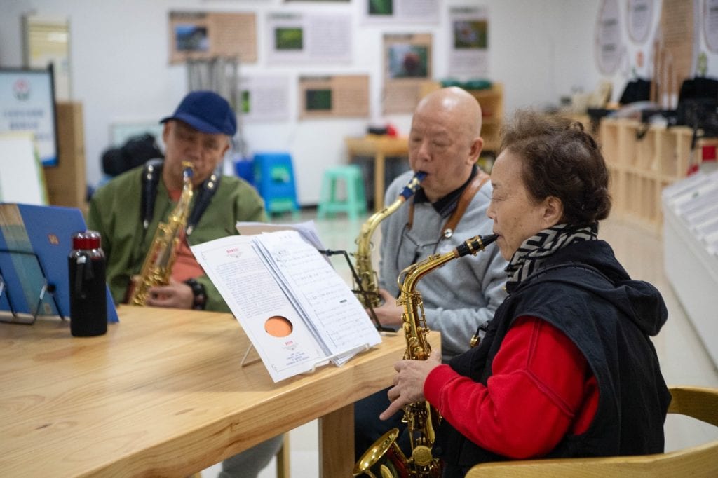 abuelos chinos tocando música en grupo ocio adultos mayores China