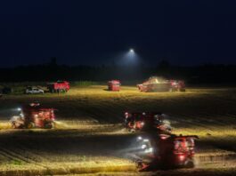 Cosechadoras y maquinaria agrícola trabajan durante la noche en un establecimiento rural de China con iluminación y tecnología de última generación.